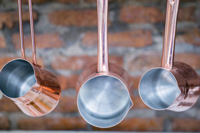 Close-up of metal hanging against wall