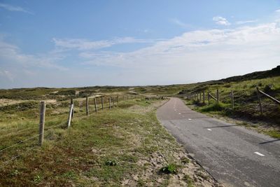 Road amidst landscape against sky