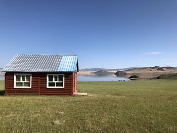 Built structure on field against clear sky mongolia