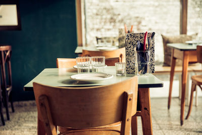 Empty chairs and tables in cafe