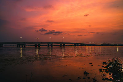 Scenic view of sea against orange sky