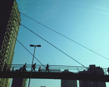 Low angle view of cables against blue sky