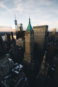 Aerial view of city against cloudy sky