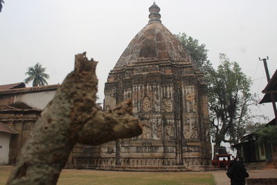 View of temple against building