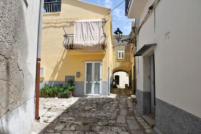 A narrow street among the old houses of irsina in basilicata, region in southern italy.