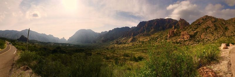 Scenic view of mountains against cloudy sky