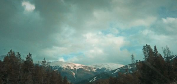 Scenic view of mountains against cloudy sky