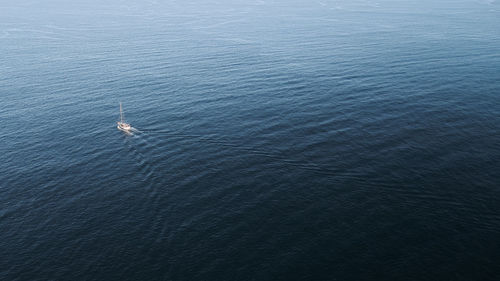 A boat sailing alone in ocean.