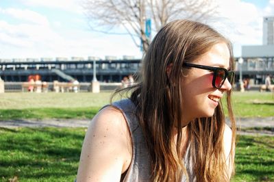 Smiling woman wearing sunglasses during sunny day