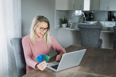 Young woman using mobile phone at home