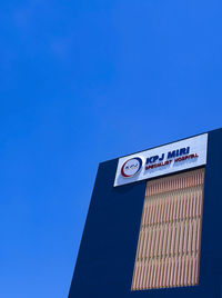 Low angle view of information sign against clear sky