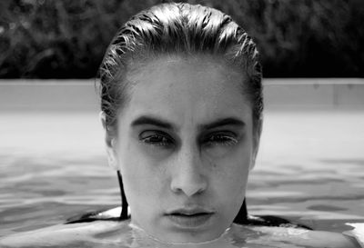 Close-up portrait of young woman in swimming pool