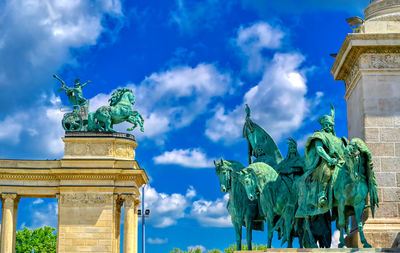 Low angle view of statue against cloudy sky