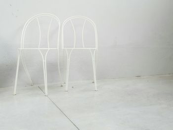 White metallic chairs on floor at home