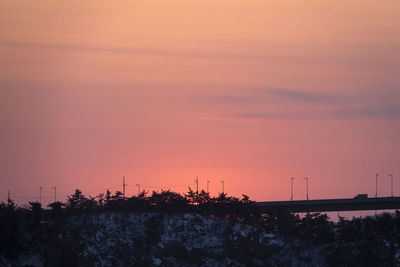 Silhouette trees against sky during sunset