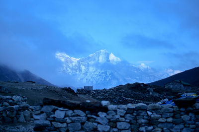 Scenic view of snowcapped mountains against blue sky