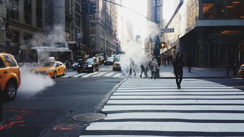 People with smoke on street in city