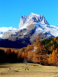 Snowcapped mountains and landscape against blue sky during autumn at european alps