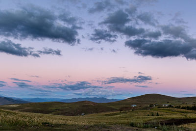 Scenic view of field against sky during sunset