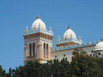 Low angle view of historical building against clear blue sky