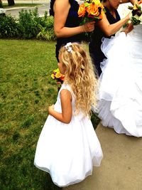 Midsection of mother and girl holding flower