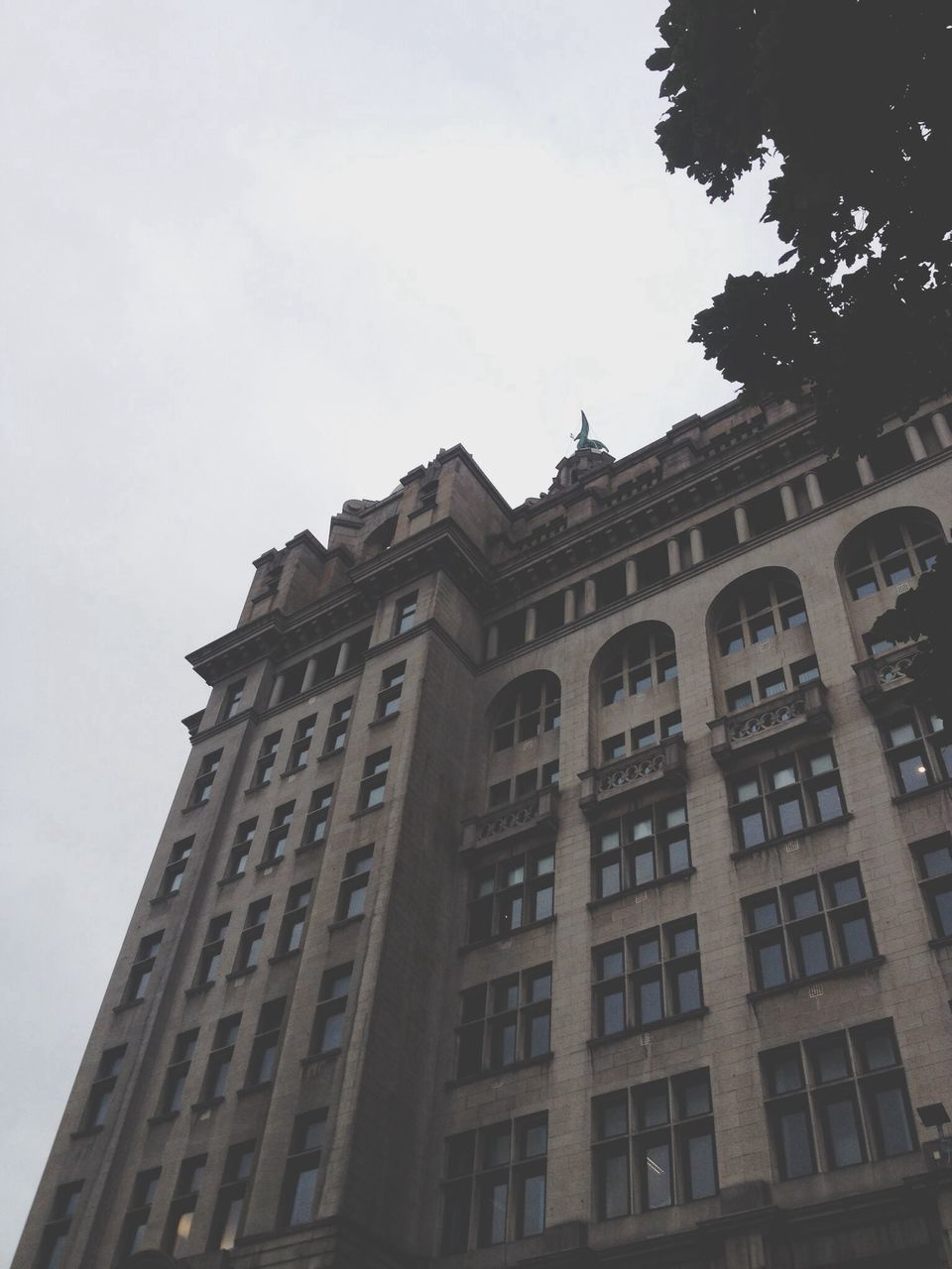 architecture, building exterior, built structure, low angle view, window, sky, building, city, outdoors, residential building, day, no people, clear sky, residential structure, facade, high section, tall - high, tower, office building, city life