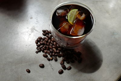 High angle view of coffee beans in glass on table