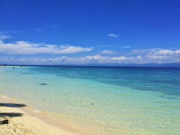 Scenic view of sea against blue sky