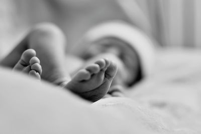 Baby lying on bed at home