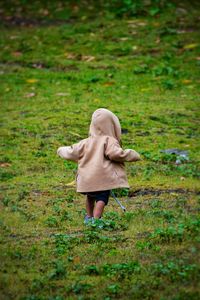 Kid sprinting through grassland meadows 