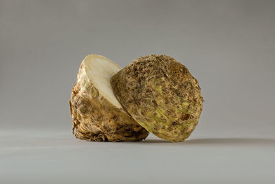 Close-up of bread on table against white background