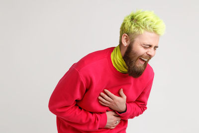 Portrait of smiling young man against white background