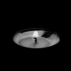 Close-up of lit candle in darkroom