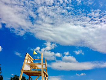 Low angle view of windmill against blue sky