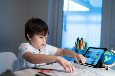 Portrait of boy using mobile phone