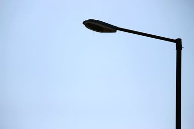 Low angle view of windmill against clear blue sky