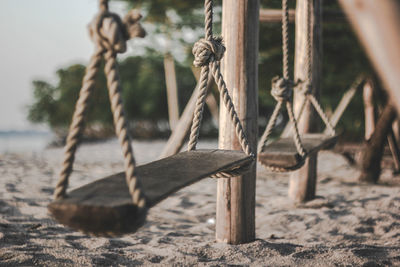 Close-up of rope tied to wooden post