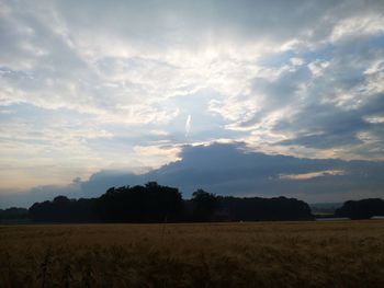 Scenic view of field against sky during sunset