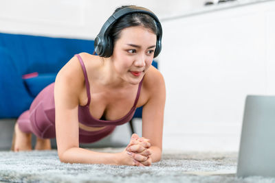 Young woman exercising at home