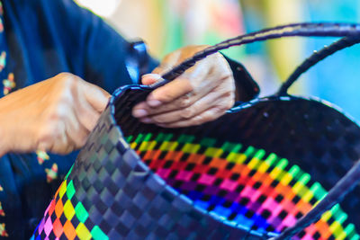 Midsection of woman making bag