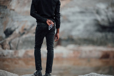 Low section of man standing on land