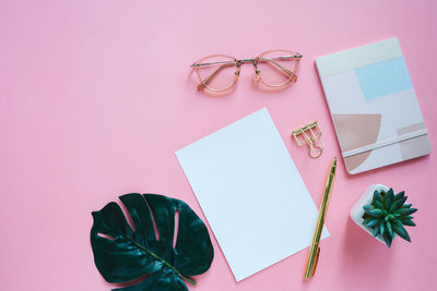 Directly above shot of objects against pink background