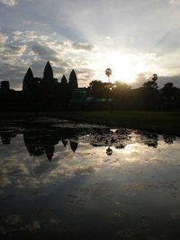 Reflection of church in lake during sunset