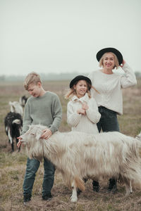 Portrait of smiling family walking on field