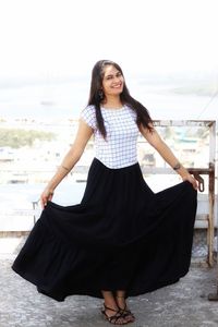 Portrait of smiling young woman standing outdoors