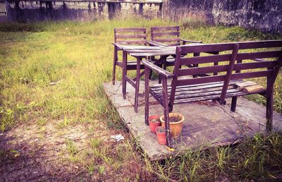 Empty bench on grassy field