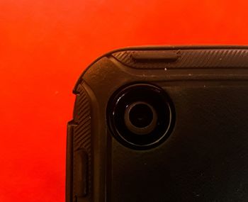 Close-up of metal door against red background