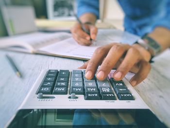 Close-up of man working on the table