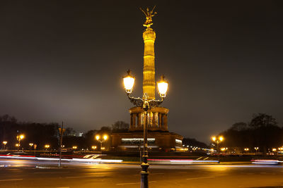 Illuminated street light in city at night