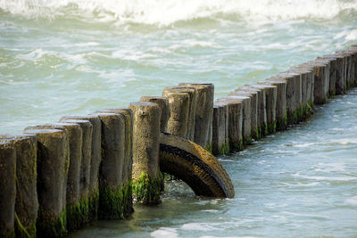 Wooden posts in sea